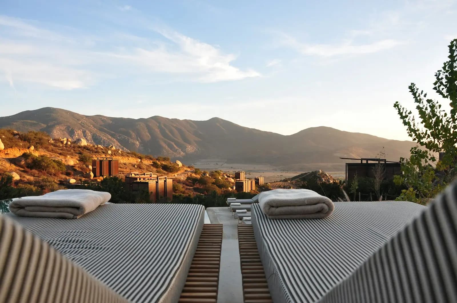 A hillside property at sunset, terraces looking out over the valley